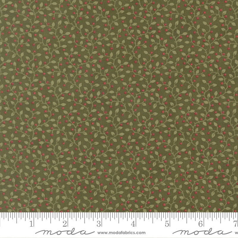 Green fabric with small red berry pattern and ruler.