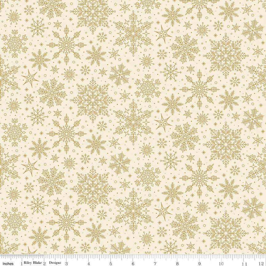 Pattern of gold snowflakes on a beige background with a ruler at the bottom.