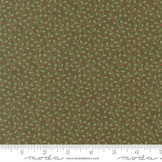 Green fabric with small red berry pattern and ruler.