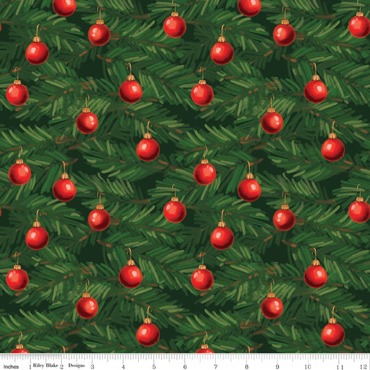 A repeating Christmas tree branch pattern with green pine needles and red ornament illustrations, shown as a fabric or wallpaper print. A small ruler strip along the bottom edge shows scale.