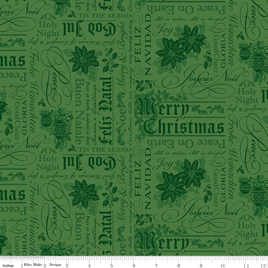 Green fabric with Christmas text and poinsettia patterns on a white ruler background