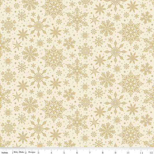 Pattern of gold snowflakes on a beige background with a ruler at the bottom.