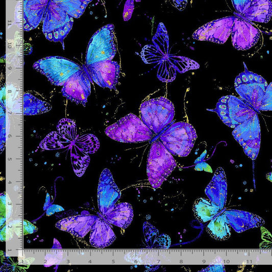 Butterfly pattern with blue and purple colors on a black background, measured against a ruler.