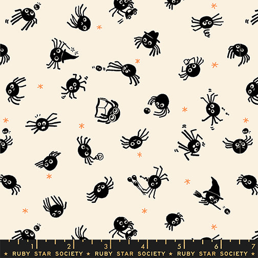 Pattern of black spiders on a beige background with a ruler at the bottom.