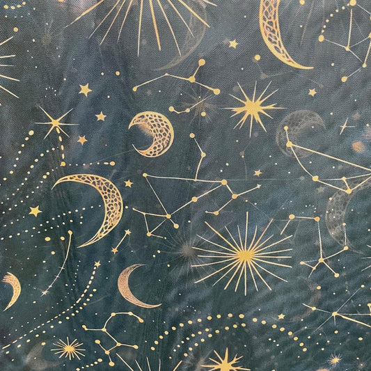 Dark teal fabric featuring a repeating celestial pattern of gold crescent moons, stars, and constellations.