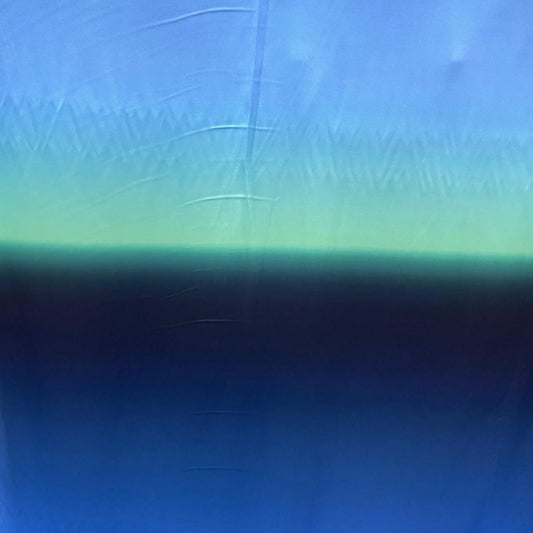 A  blue fabric with a horizontal gradient transitioning from light sky blue at the top to a darker navy blue at the bottom, with a soft mint-green band across the middle.